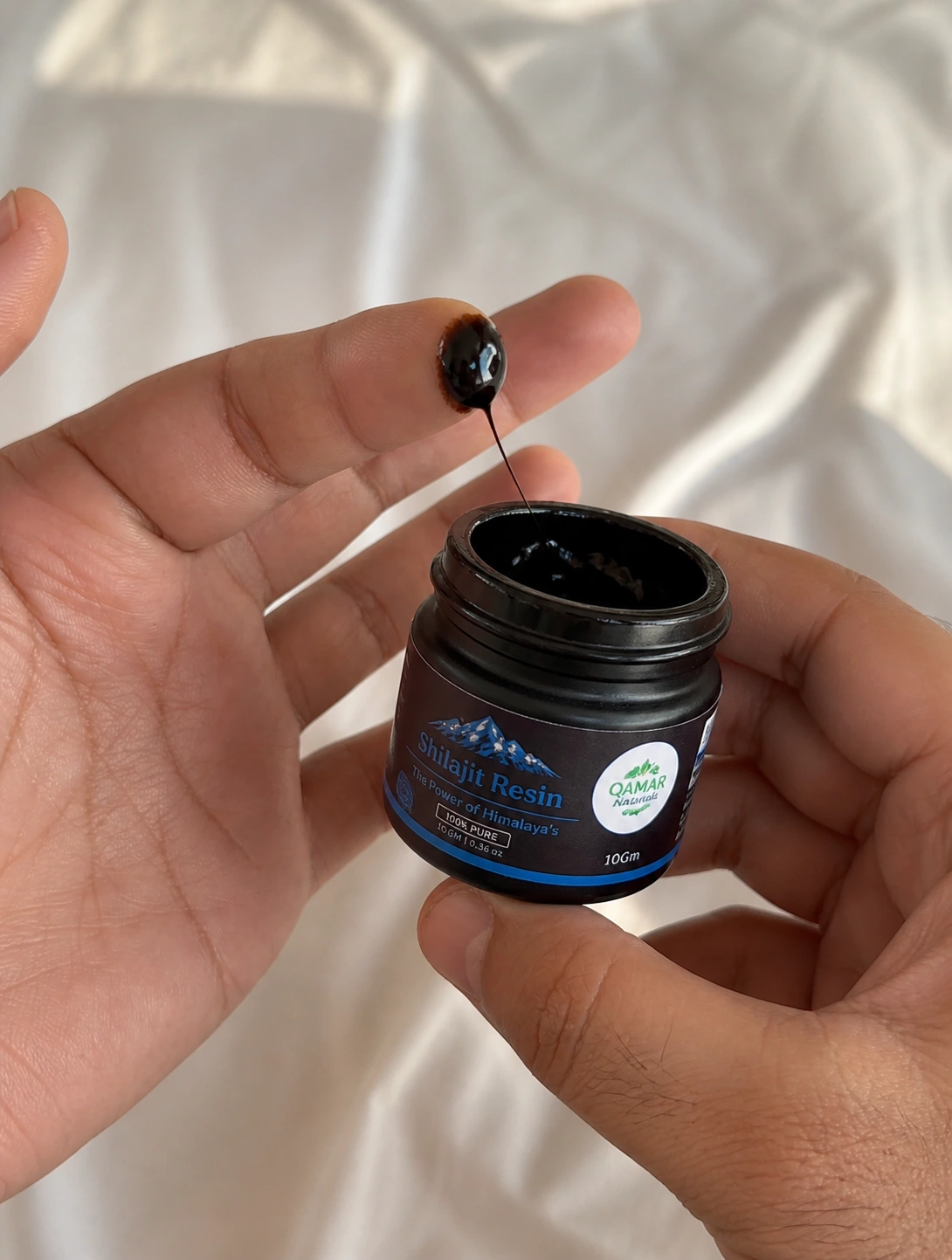 Close-up texture of Shilajit resin showing thick natural consistency