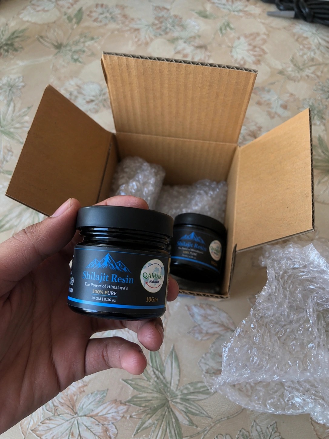 Customer unboxing Qamar Naturals Omega 3 bottles